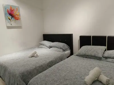 two beds with stuffed animals on them in a bedroom at Heart of Ipoh 2BR 6pp in Ipoh