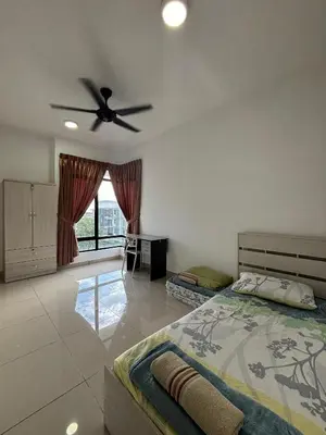 a bedroom with a bed and a ceiling fan at A well-kept unit with four bedrooms and ensuite bathrooms in Kampar