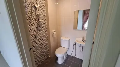a bathroom with a toilet and a sink at A well-kept unit with four bedrooms and ensuite bathrooms in Kampar