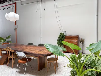 a wooden table in a room with plants at Love Linn in George Town