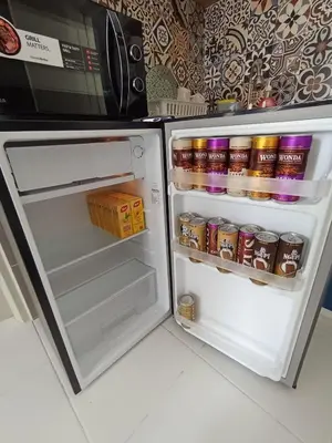 an open refrigerator with food and drinks in it at Radif Homestay Seri Iskandar with Balcony#2 in Kampong Bota Road