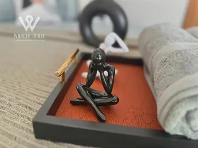 a small statue of a person sitting on a bed at Modern 3BR Retreat at Bandar Baru Air Itam near Air Itam and Kek Lok Si in Ayer Itam