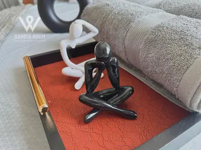 a metal statue of a person next to a book at Modern 3BR Retreat at Bandar Baru Air Itam near Air Itam and Kek Lok Si in Ayer Itam