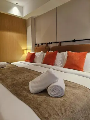 a hotel room with two beds with towels on them at The Green Hall in George Town