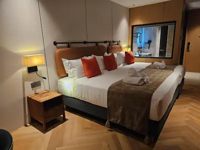 a bedroom with a large bed with two towels on it at The Green Hall in George Town