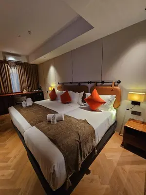a hotel room with a large bed with orange pillows at The Green Hall in George Town