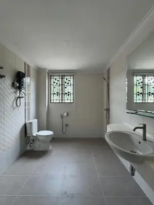 a bathroom with a tub and a toilet and a sink at Ichinichi Home in Ipoh