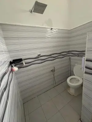 a bathroom with a toilet in a room at Welcome To Amda CS Guest House