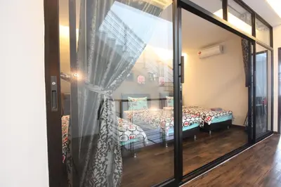 a room with a couch and a glass door at Shamrock Beach Villas 15 Seaview in George Town