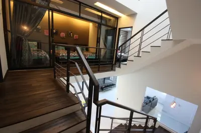 a staircase in a house with a living room at Shamrock Beach Villas 15 Seaview in George Town