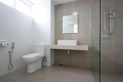 a bathroom with a toilet and a sink and a shower at Shamrock Beach Villas 15 Seaview in George Town