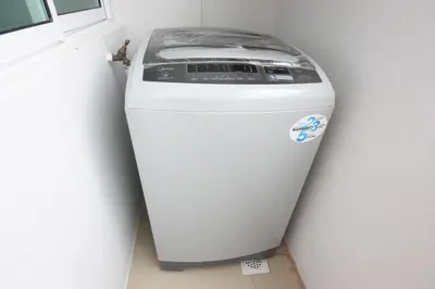 a washing machine sitting in a corner next to a wall at Shamrock Beach Villas 15 Seaview in George Town