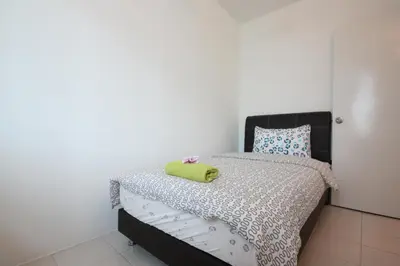 a bedroom with a bed with a green towel on it at Shamrock Beach Villas 9 Seaview in George Town