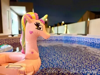 a pink toy unicorn sitting in a swimming pool at BBC Play Ipoh Homestay in Ipoh