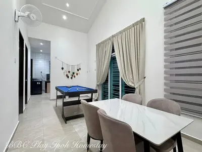 a dining room with a ping pong table and chairs at BBC Play Ipoh Homestay in Ipoh
