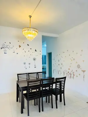 a dining room with a black table and chairs at Ayaan Family Retreat with PS4 and Netflix in Tanah Rata