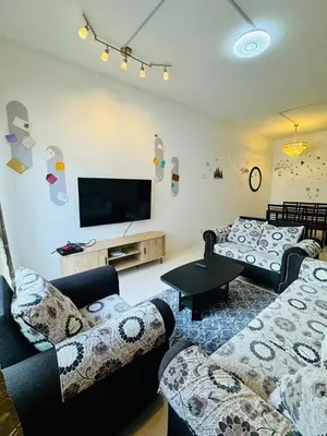 a living room with couches and a flat screen tv at AYAAN HOLIDAY INN Homestay at Tanah Rata with PS4 gaming in Tanah Rata