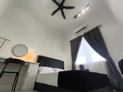 a bedroom with a bed and a ceiling fan at Inap kluster Alamanda in Kuala Kangsar