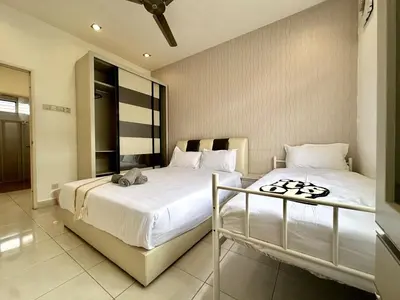 a bedroom with two beds with white sheets at Raja Uda Family Haven 4BR 10 Pax in Butterworth