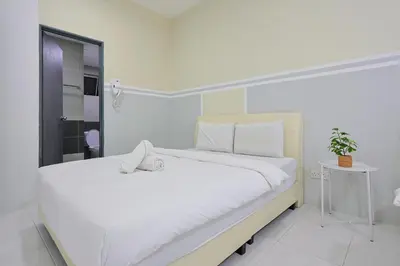 a white bedroom with a large bed with white sheets at Serenity Vacation Stay Brinchang Cameron Highland Clover home 3-25 in Brinchang