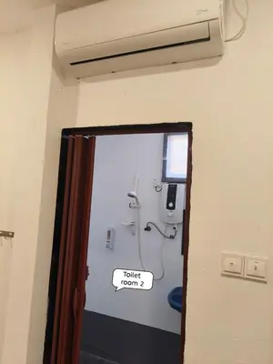 a bathroom with a toilet room sign on the wall at Putra Villa Homestay Ipoh in Ipoh