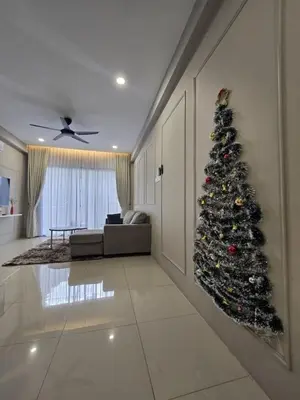 a living room with a christmas tree in the corner at 3 Bed Rooms Cozy Unit The Cove in Ipoh
