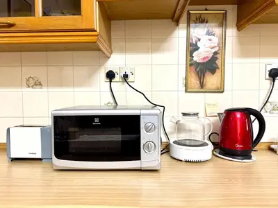 a microwave sitting on top of a kitchen counter at Simee Cozy Homestay ,Simee, Ipoh Town in Ipoh