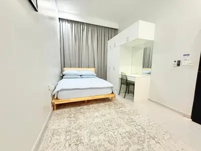 a small bedroom with a bed and a table at Adam Luxe Homestay Tapah in Tapah