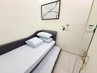 a room with a bed with two pillows on it at Adam Luxe Homestay Tapah in Tapah