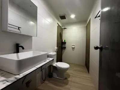 a white bathroom with a sink and a toilet at Adam Luxe Homestay Tapah in Tapah