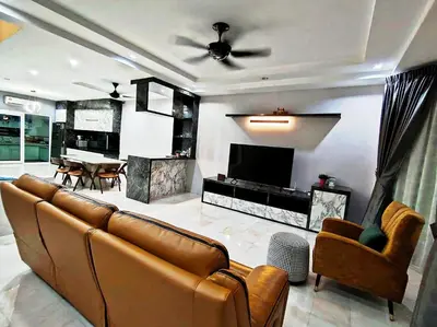 a living room with a couch and a television at Ipoh FamilyHub by One Life Four Season Guesthouse in Ipoh