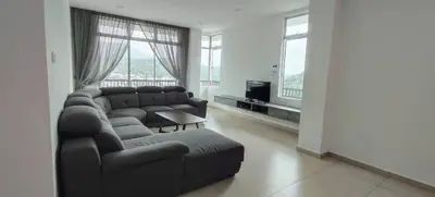 a living room with a couch and a tv at Ereens penthouse Cameron highland in Brinchang