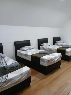 a group of four beds in a room at Ereens penthouse Cameron highland in Brinchang