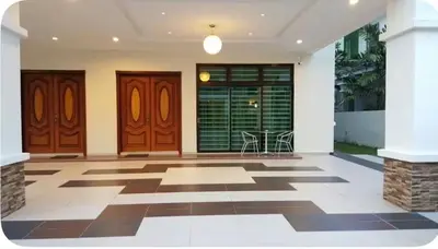a lobby with two wooden doors and a checkered floor at Woon homestay 2 in Balik Pulau