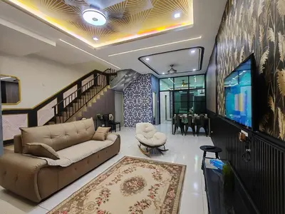 a living room with a couch and a tv at Lahat Mines Signature Stay in Lahat
