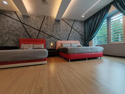 two beds and a couch in a room at Lahat Mines Signature Stay in Lahat