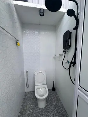 a small bathroom with a toilet and a shower at Lumen Stay in Bukit Mertajam