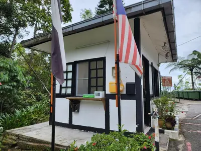 a small house with a flag in front of it at Little England B5-1 Fraser Panorama in Bukit Fraser