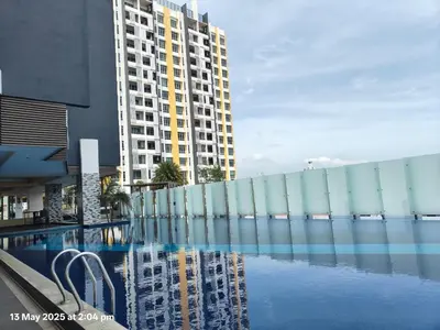 a swimming pool in front of a tall building at Ipoh Poolside 7th Floor 3BR Homestay in Ipoh
