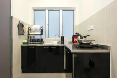 a kitchen with black cabinets and a sink and a window at SpongeBob Fun Family Homestay In Brinchang Cameron Highland Clover Home 7-02 in Brinchang