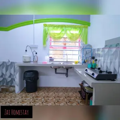 a kitchen with a table and a window in a room at Zai homestay in Kampung Jeram Kawang