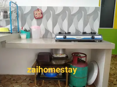 a toy kitchen with a toy stove on a shelf at Zai homestay in Kampung Jeram Kawang