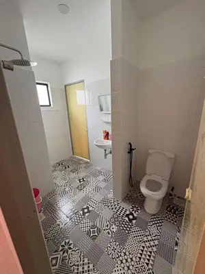 a bathroom with a toilet and a sink at Luxury House Panoramic Views and Elegant Comfort in Batu Gajah