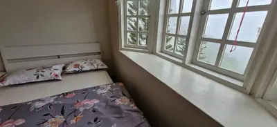 a bedroom with a bed and two windows at B43A2 Silverpark Resort Best Mountain view Walk up 1 floor in Bukit Fraser
