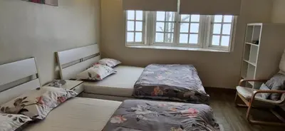 two twin beds in a room with a window at B43A2 Silverpark Resort Best Mountain view Walk up 1 floor in Bukit Fraser