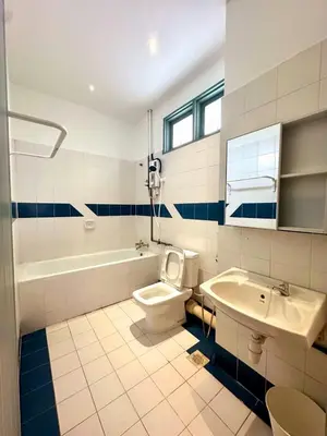 a bathroom with a toilet and a tub and a sink at Bagan Cozy Family Retreat 4BR 10 Pax in Butterworth