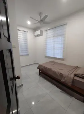 a bedroom with a bed and a ceiling fan at Sweet Home in Balik Pulau