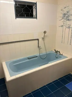 a bath tub with a shower in a bathroom at 786 Bali Top Homestay in Sungai Petani