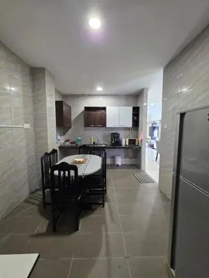 a kitchen and dining room with a table and chairs at Teeview Homes in Tanah Rata