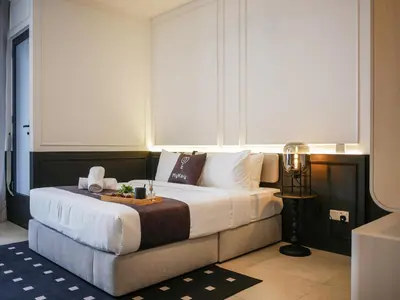 a hotel room with a bed with a tray on it at 22 Macalisterz by Mana Mana in George Town